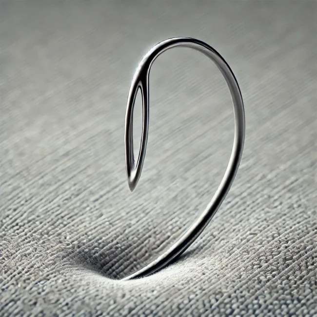 Imagen de una aguja curva mostrando su forma única y aplicación en costura.