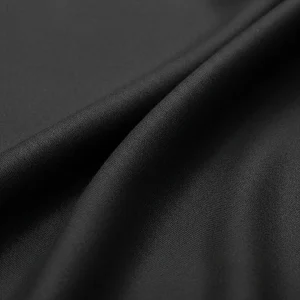 Macro de tejido Casimir de lana peinada fina color gris marengo, mostrando su superficie lisa y lustre sutil. Tela de alta calidad para trajes.